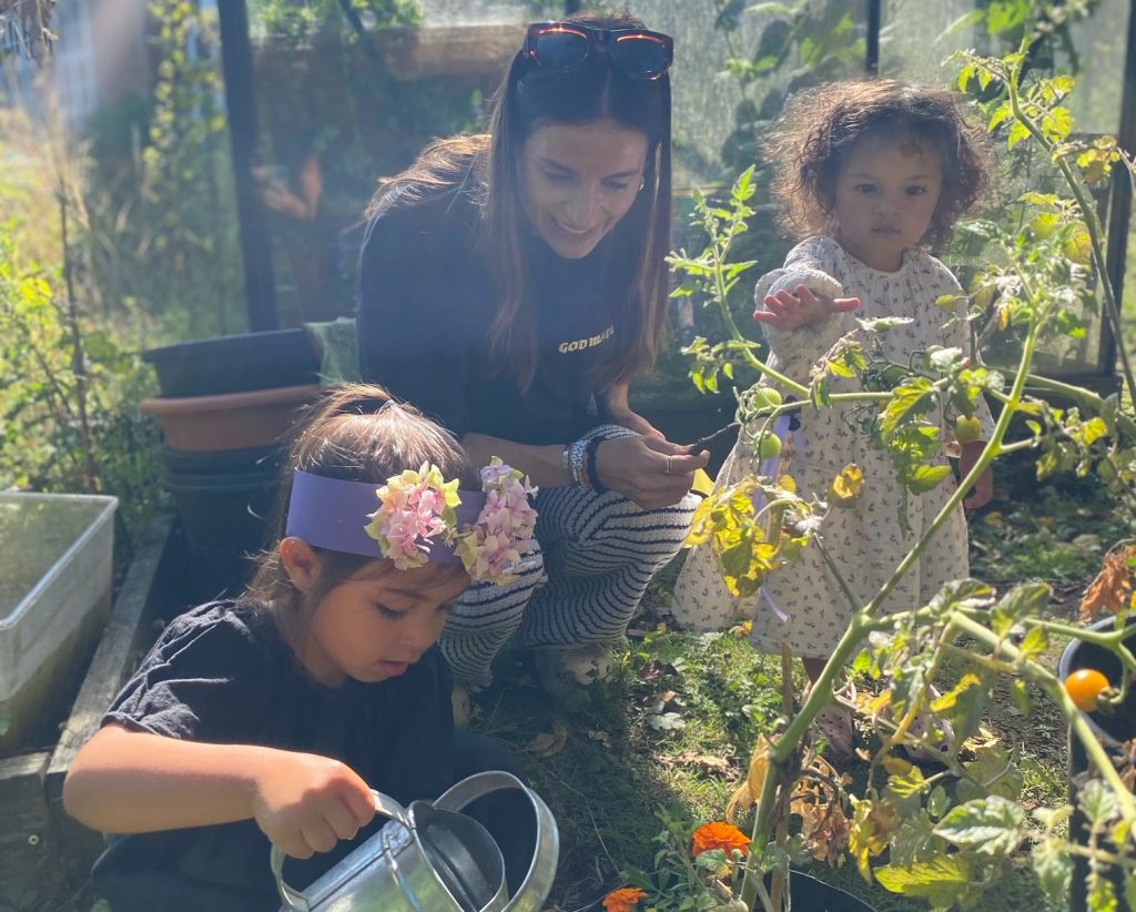watering tomatoes with children